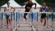 FILE - Damian Warner competes in the semifinal 100m hurdles at the Canadian Track and Field Olympic trials in Montreal, Saturday, June 29, 2024. THE CANADIAN PRESS/Christinne Muschi