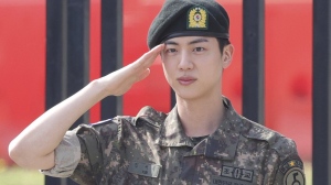 K-pop band BTS's member Jin salutes after being discharged from a mandatory military service outside of an army base in Yeoncheon, South Korea, Wednesday, June 12, 2024. (Im Byung-shik/Yonhap via AP)