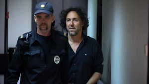 French citizen Laurent Vinatier, right, is escorted into a cage in a courtroom in the Zamoskvoretsky District Court in Moscow, Russia on Friday, June 7, 2024.(AP Photo)