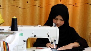 An Afghan woman tailor works with a sewing machine in the Afghan Women Business Hub in Kabul, Afghanistan, Tuesday, July 2, 2024. (AP Photo/Siddiqullah Alizai)