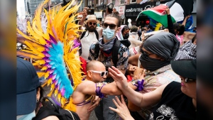 A pride marcher clashes with pro Palestinian protesters as they disrupt the Toronto Pride Parade, on Sunday, June 30, 2024. THE CANADIAN PRESS/Arlyn McAdorey 