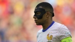 Kylian Mbappe of France wears a face mask during a round of sixteen match between France and Belgium at the Euro 2024 soccer tournament in Duesseldorf, Germany, Monday, July 1, 2024. (AP Photo/Martin Meissner)