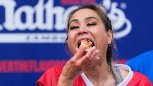 Miki Sudo competes in the women's division of Nathan's Famous Fourth of July hot dog eating contest, Thursday, July 4, 2024, at Coney Island in the Brooklyn borough of New York. (AP Photo/Julia Nikhinson) 
