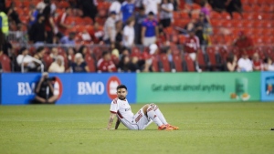 Toronto FC forward Lorenzo Insigne (24) sits on the turf after losing to Orlando City SC in an MLS soccer match in Toronto on July 3, 2024. THE CANADIAN PRESS/Cole Burston