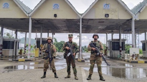 In this handout photo provided by Mandalay People's Defence Force, members of the Ta'ang National Liberation Army, one of the ethnic armed forces in the Brotherhood Alliance, and the Mandalay People's Defence Force pose for a photograph in front of the captured toll-gate in Nawnghkio township in Shan state, Myanmar, June 26, 2024. (Mandalay People's Defence Force via AP)