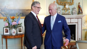 King Charles III, right, speaks with Keir Starmer where he invited the Labour Party leader to become prime minister and to form a new government, following the landslide general election victory for the Labour Party, in London, Friday, July 5, 2024. (Yui Mok, Pool Photo via AP) 