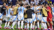 Players of Argentina celebrate defeating Ecuador in a penalty shootout in a Copa America quarterfinal soccer match in Houston, Thursday, July 4, 2024. (AP Photo/Julio Cortez)