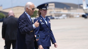 President Joe Biden, left, gestures before boarding Air Force One at Andrews Air Force Base, Md., as he leaves for a campaign trip to Madison, Wis., Friday, July 5, 2024. (AP Photo/Manuel Balce Ceneta)