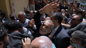 Reformist candidate for the Iran's presidential election Masoud Pezeshkian waves as he arrives to vote at a polling station in Shahr-e-Qods near Tehran, Iran, Friday, July 5, 2024.(AP Photo/Vahid Salemi)