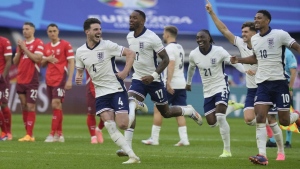 England players celebrate after Trent Alexander-Arnold scored the winning goal during the penalty shootout of a quarterfinal match between England and Switzerland at the Euro 2024 soccer tournament in Duesseldorf, Germany, Saturday, July 6, 2024. (AP Photo/Martin Meissner)