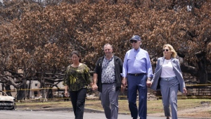 President Joe Biden and first lady Jill Biden walk with Hawaii Gov. Josh Green, second from left, and his wife Jaime Green as they pass the massive Banyan tree while visiting areas devastated by the Maui wildfires, Aug. 21, 2023, in Lahaina, Hawaii. (AP Photo/Evan Vucci, File)