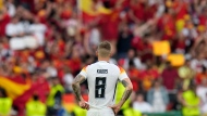 Germany's Toni Kroos watches fans celebrate at the end of a quarter final match between Germany and Spain at the Euro 2024 soccer tournament in Stuttgart, Germany, Friday, July 5, 2024. (AP Photo/Ariel Schalit)