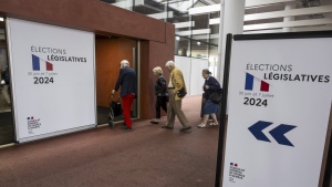 French people living in Switzerland arrive to cast their ballots for the second round of French legislative elections at a polling station in Geneva, Switzerland, Sunday, July 7, 2024. (Martial Trezzini/AP Photo)