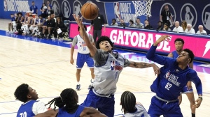Team Herscu's Izan Almansa, centre, reaches for a rebound as Team Forehn-Kelly's Ulrich Chomche (62) watches during the NBA draft combine 5-on-5 basketball game in Chicago, Wednesday, May 15, 2024. Chomche has signed a two-way contract with the Toronto Raptors. THE CANADIAN PRESS/AP/Nam Y. Huh