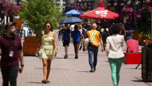 People make their way through downtown Ottawa on Tuesday, June 18, 2024, as temperatures hit 32C in what meteorologists are calling a heat dome. THE CANADIAN PRESS/Sean Kilpatrick