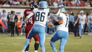 Toronto Argonauts wide receiver Damonte Coxie (86) celebrates his touchdown over Montreal Alouettes with quarterback Cameron Dukes (11) during first half CFL football action in Montreal, Thursday, July 11, 2024. THE CANADIAN PRESS/Christinne Muschi