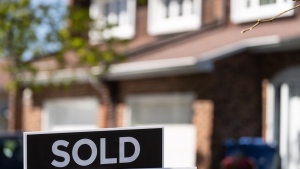 A real estate sign is posted outside a home in Montreal on May 7, 2024. THE CANADIAN PRESS/Christinne Muschi