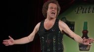 FILE - In this June 2, 2006, file photo, Richard Simmons speaks to the audience before the start of a summer salad fashion show at Grand Central Terminal in New York.  (AP Photo/Tina Fineberg, File)
