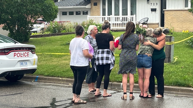 Friends of Andrieana Montegomery can be seen in front of her home on Monday. (Beth Macdonell)