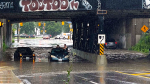 People can be seen stuck in flooding after heavy rainfall in Toronto on July 16, 2024. 