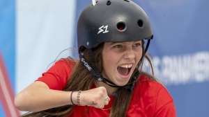 Canada's Fay De Fazio Ebert, of Toronto, celebrates during her gold medal performance, while wearing on feather from her pet duck in her helmet, at the Women's Park Skateboarding at the Pan American Games in Santiago, Chile on October 22, 2023. THE CANADIAN PRESS/Frank Gunn