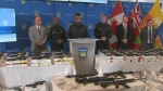 Police and other officials are shown at a news conference on July 17 where they announced the seizure of 71 illegal firearms. (CP24)