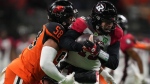B.C. Lions' Woody Baron, left, sacks Ottawa Redblacks quarterback Nick Arbuckle during the first half of CFL football game in Vancouver, on Friday, September 30, 2022. The Toronto Argonauts signed veteran defensive lineman Baron on Wednesday.THE CANADIAN PRESS/Darryl Dyck