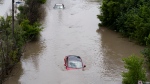 Cars are partially submerged in flood waters in the Don Valley following heavy rain in Toronto on July 16 2024. THE CANADIAN PRESS/Arlyn McAdorey