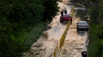 Cars remain stranded on Bayview Avenue as water recedes following heavy rain that caused flooding, in Toronto on Tuesday, July 16, 2024. THE CANADIAN PRESS/Christopher Katsarov 