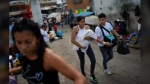 Residents walk through the Petare neighborhood of Caracas, Venezuela, Tuesday, July 16, 2024. (AP Photo/Ariana Cubillos)