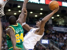 Toronto Raptors forward Chris Bosh (right) soars to the hoop against Utah Jazz guard Paul Millsap (24) during fourth quarter NBA action in Toronto on Wednesday March 24, 2010. (THE CANADIAN PRESS/Frank Gunn)