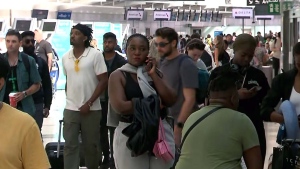 People are shown at Pearson International Airport on July 19. Widespread delays were reported at the airport as a result of a global IT outage. 