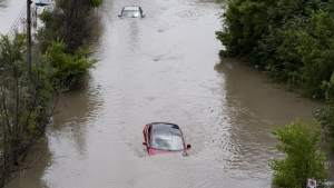 Cars are partially submerged in flood waters in the Don Valley following heavy rain in Toronto on July 16, 2024. THE CANADIAN PRESS/Arlyn McAdorey