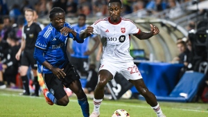 CF Montreal's Kwadwo Opoku, left, moves in on Toronto FC's Richie Laryea (22) during second half MLS soccer action in Montreal, Saturday, July 20, 2024. THE CANADIAN PRESS/Graham Hughes