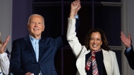 U.S. President Joe Biden raises the hand of Vice President Kamala Harris as they view the Independence Day firework display over the National Mall from the balcony of the White House, Thursday, July 4, 2024, in Washington. (Evan Vucci/AP Photo)