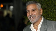 FILE - George Clooney, a cast member in "Ticket to Paradise," poses at the premiere of the film, Monday, Oct. 17, 2022, at the Regency Village Theatre in Los Angeles. Just weeks after headlining a record-breaking fundraiser for the president's reelection campaign, Clooney wrote a New York Times opinion piece calling for Biden to end his bid. (AP Photo/Chris Pizzello, File)