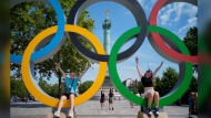 Kids play in Olympic rings set up on Place de la Bastille, Friday, July 19, 2024, in Paris, France. The International Olympic and Paralympic committees allowing some Russian and Belarusian athletes entry into the 2024 Summer Games is a thorny topic. THE CANADIAN PRESS/AP/David Goldman