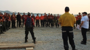 Division supervisors from New Brunswick and Ontario deliver a morning briefing to wildland firefighters at the Algar Lake Complex near Fort McMurray, Alta., in a Saturday, July 20, 2024, handout photo. THE CANADIAN PRESS/HO-Government of Alberta