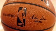 FILE - An NBA logo is seen on an official game ball before a basketball game, Feb. 1, 2014, in New York.  (AP Photo/Jason DeCrow, file)