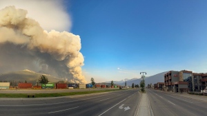 A wildfire burns as an empty street in Jasper, Alta. is shown in this Wednesday, July 24, 2024 handout photo from the Jasper National Park Facebook page. THE CANADIAN PRESS/HO, Facebook, Jasper National Park