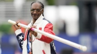 Snoop Dogg gets a pole vaulting lesson during the U.S. Track and Field Olympic Team Trials on June 23, 2024, in Eugene, Ore. Snoop will be one of the final torchbearers of the Olympic flame ahead of the Games’ opening ceremony Friday, July 26. (AP Photo/Charlie Neibergall, File)
