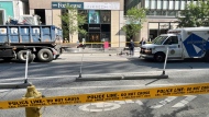 Police tape is shown at the scene after a cyclist was struck by a dump truck on Bloor Street West on July 25. (Ken Enlow)