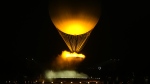 The lighting of cauldron involving a hot air ballon is shown during the opening ceremony for the 2024 Summer Olympics in Paris on Friday, July 26, 2024. THE CANADIAN PRESS/Adrian Wyld