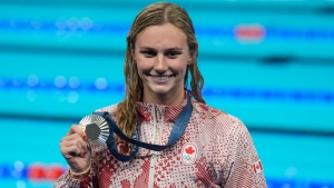 Summer McIntosh, of Canada, smiles as she holds her silver medal after the women's 400-meter freestyle final at the 2024 Summer Olympics, Saturday, July 27, 2024, in Nanterre, France. THE CANADIAN PRESS/Adrian Wyld