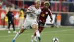 Toronto FC's Federico Bernardeschi, left, drives the ball while followed by New York Red Bulls' Kyle Duncan, right, during a Leagues Cup soccer match at Red Bull Arena, Saturday, July 27, 2024, in Harrison, N.J. (AP Photo/Andres Kudacki)