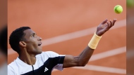 Canada's Felix Auger-Aliassime serves against Ben Shelton of the U.S. during their third round match of the French Open tennis tournament at the Roland Garros stadium in Paris, Friday, May 31, 2024. Auger-Aliassime and Bianca Andreescu started off Sunday’s matches at the Paris Olympics with straight-set victories. THE CANADIAN PRESS/AP/Jean-Francois Badias