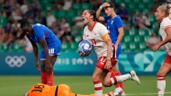 Canada's Jessie Fleming holds the ball as she celebrates after scoring her side's opening goal during the women's Group A soccer match between Canada and France at Geoffroy-Guichard stadium during the 2024 Summer Olympics, Sunday, July 28, 2024, in Saint-Etienne, France. (The Canadian Press/AP-Silvia Izquierdo)