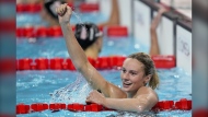 Summer McIntosh, of Canada, celebrates after winning the women's 400-meter individual medley final at the 2024 Summer Olympics, Monday, July 29, 2024, in Nanterre, France. (AP Photo/Bernat Armangue)