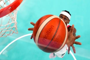 Canada's Shai Gilgeous-Alexander grabs a rebound during a men's basketball game aa; at the 2024 Summer Olympics, Tuesday, July 30, 2024, in Villeneuve-d'Ascq, France. (AP Photo/Michael Conroy, Pool)