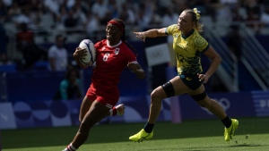 Canada's Charity Williams outruns Australia's Maddison Levi as she runs in to score at the end of first half of women's rugby sevens semi-final action, Tuesday, July 30, 2024 in Paris. THE CANADIAN PRESS/Adrian Wyld
